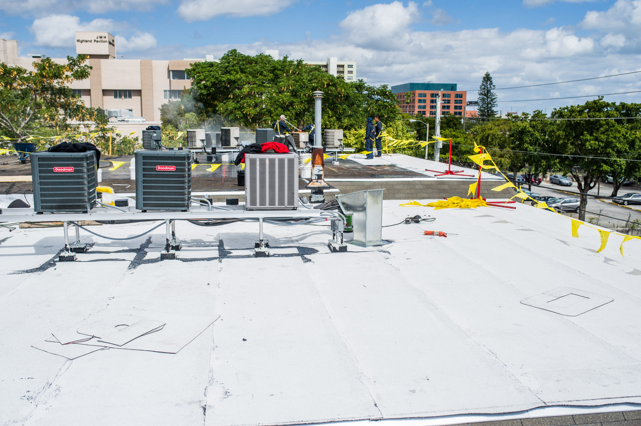 Cool roof installation in Miami Florida with reflective white roofing membrane