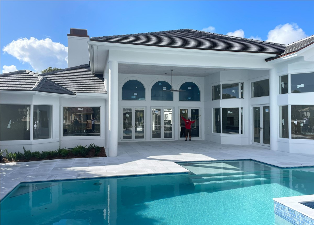 Hurricane impact windows installed on a Miami home exterior, blocking storm wind and outside street noise
